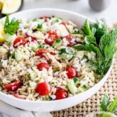 Orzo Pasta salad in a white bowl on a table.