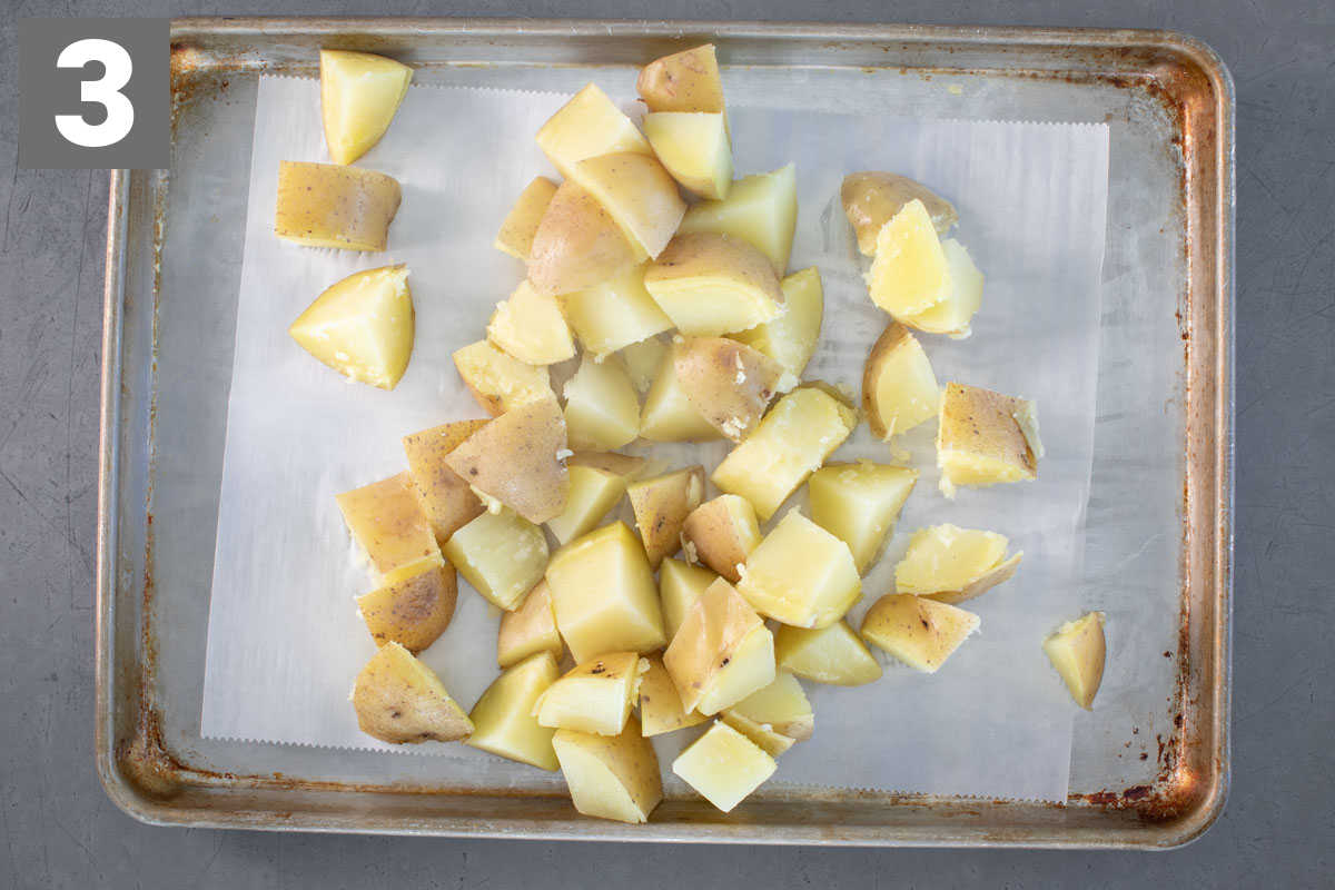 cooling the potatoes on a sheet pan lined with parchment