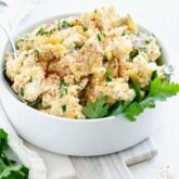 classic potato salad in a white bowl with backlight