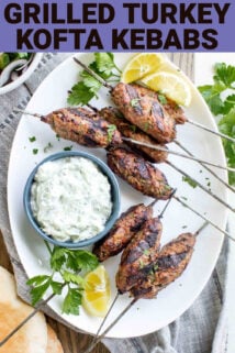 Grilled turkey kofta kebabs on skewers beside a bowl of greek yogurt cucumber sauce with text overlay