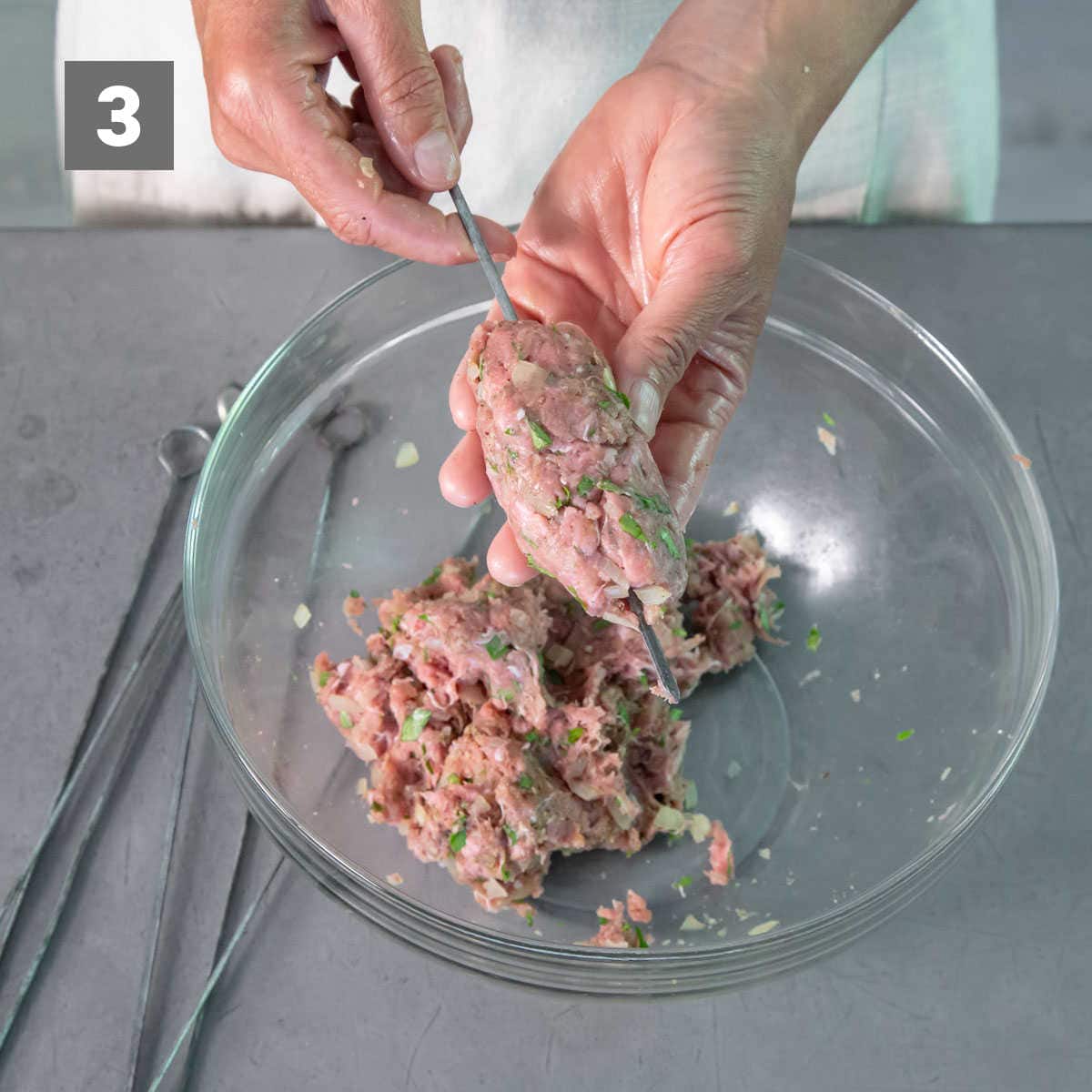 shaping kofta meat and putting it on skewers