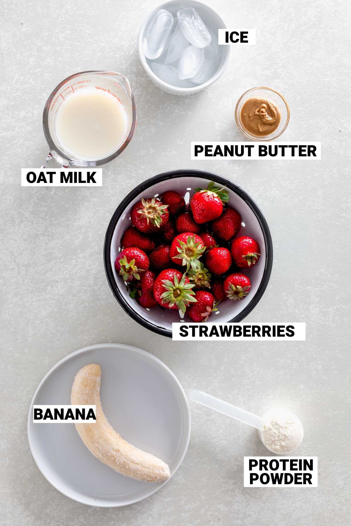 fresh strawberries and other ingredients on table for this smoothie with text overlay