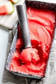 watermelon sorbet being scooped out of a pan