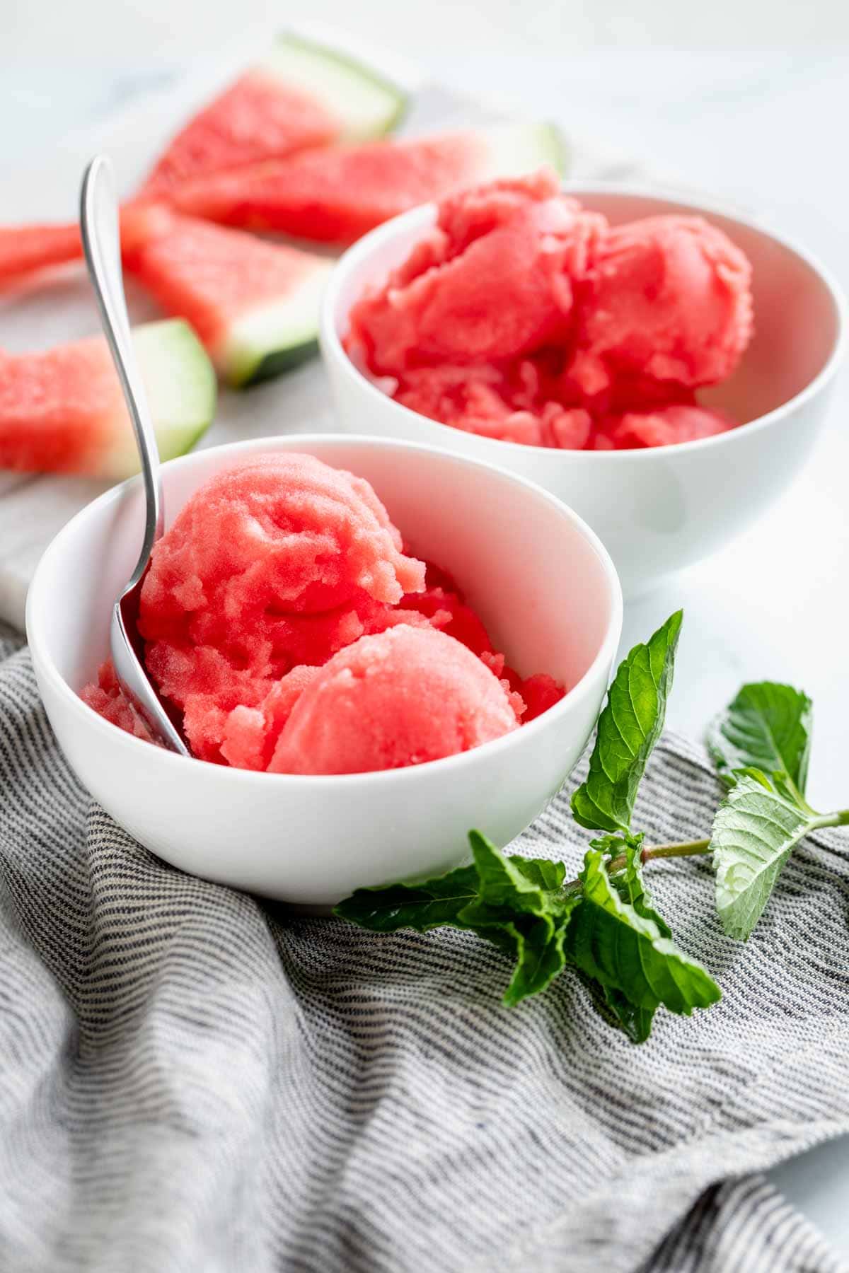 two bowls of watermelon sorbet with a spoon