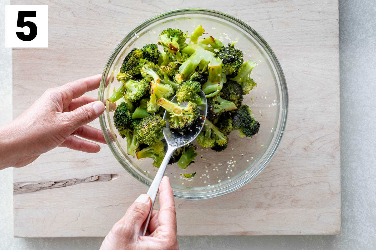 Tossing grilled broccoli with sesame seeds and seasoned rice vinegar