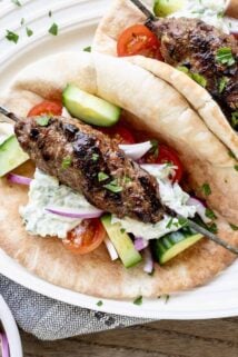 grilled ground turkey kofta kebabs in a pita pocket with tzatziki sauce