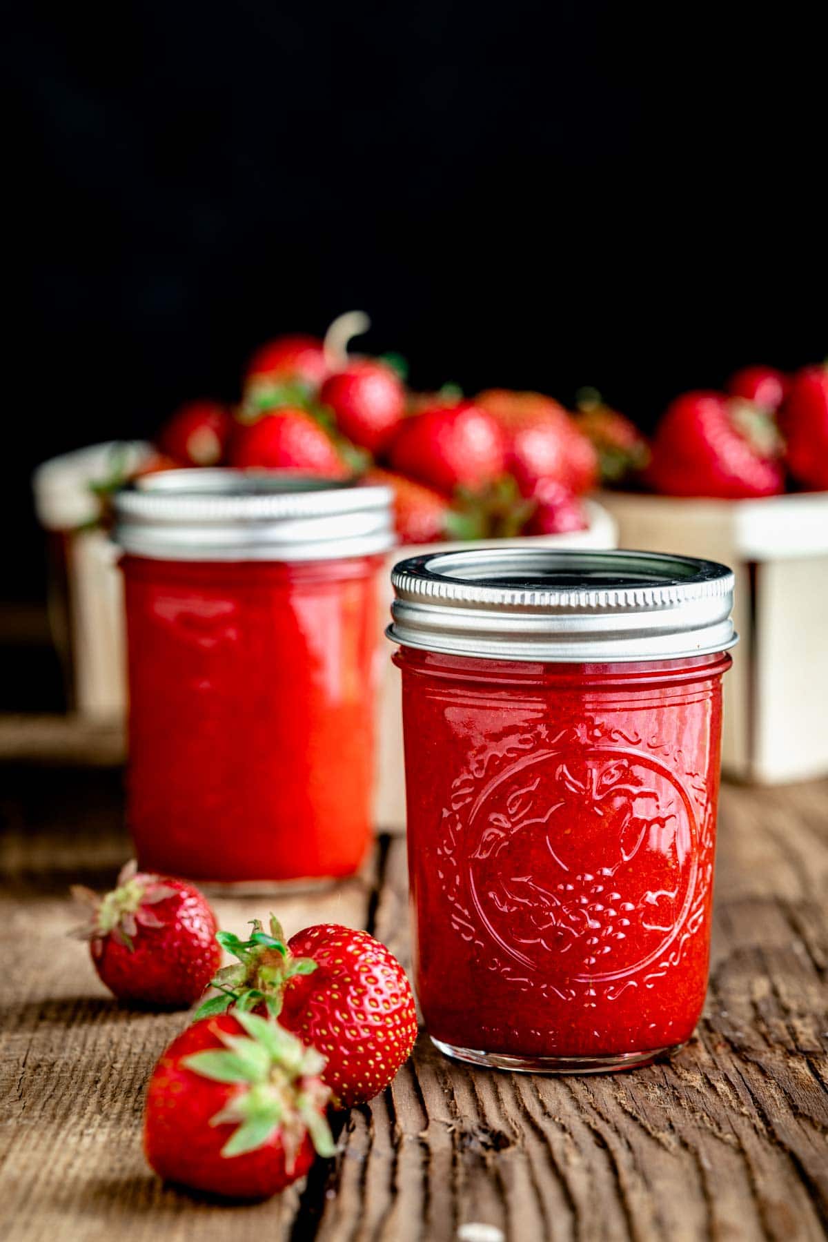 jars of coulis on a wooden table