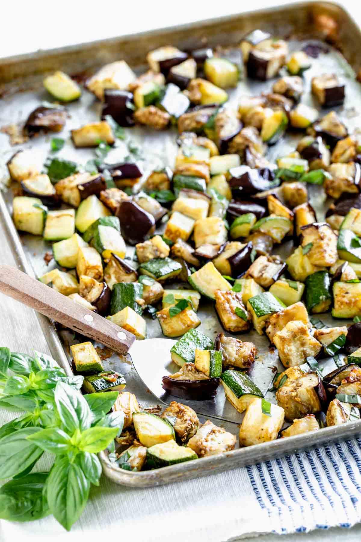 roasted 1 inch cubes of eggplant and zucchini on a baking sheet