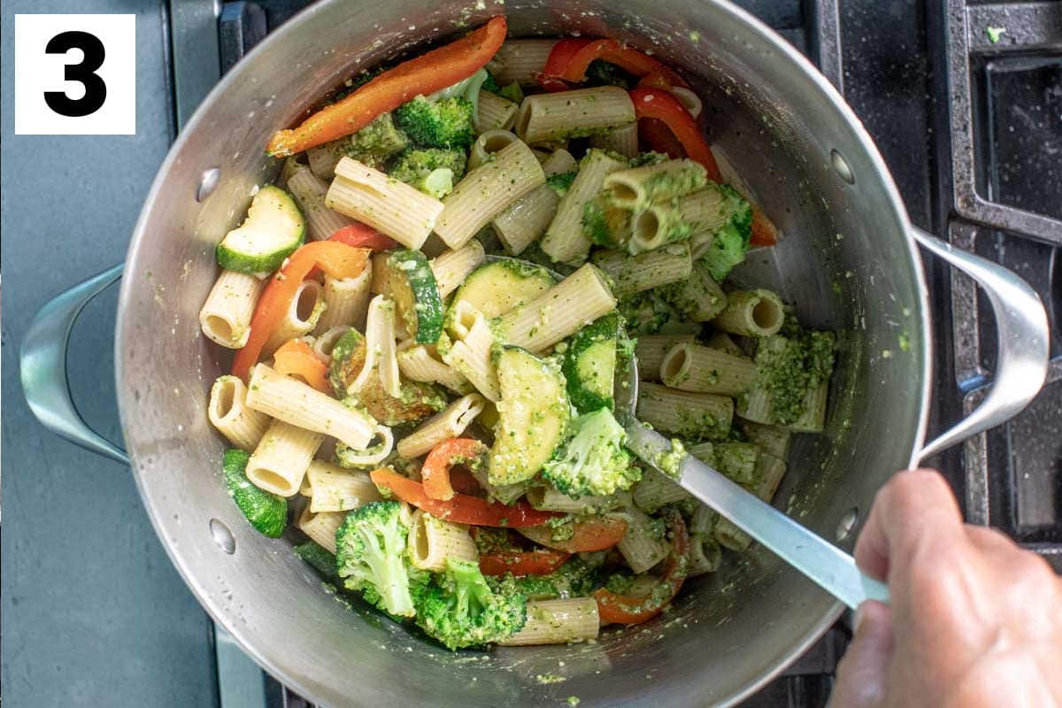 combining pasta and veggies in a pot
