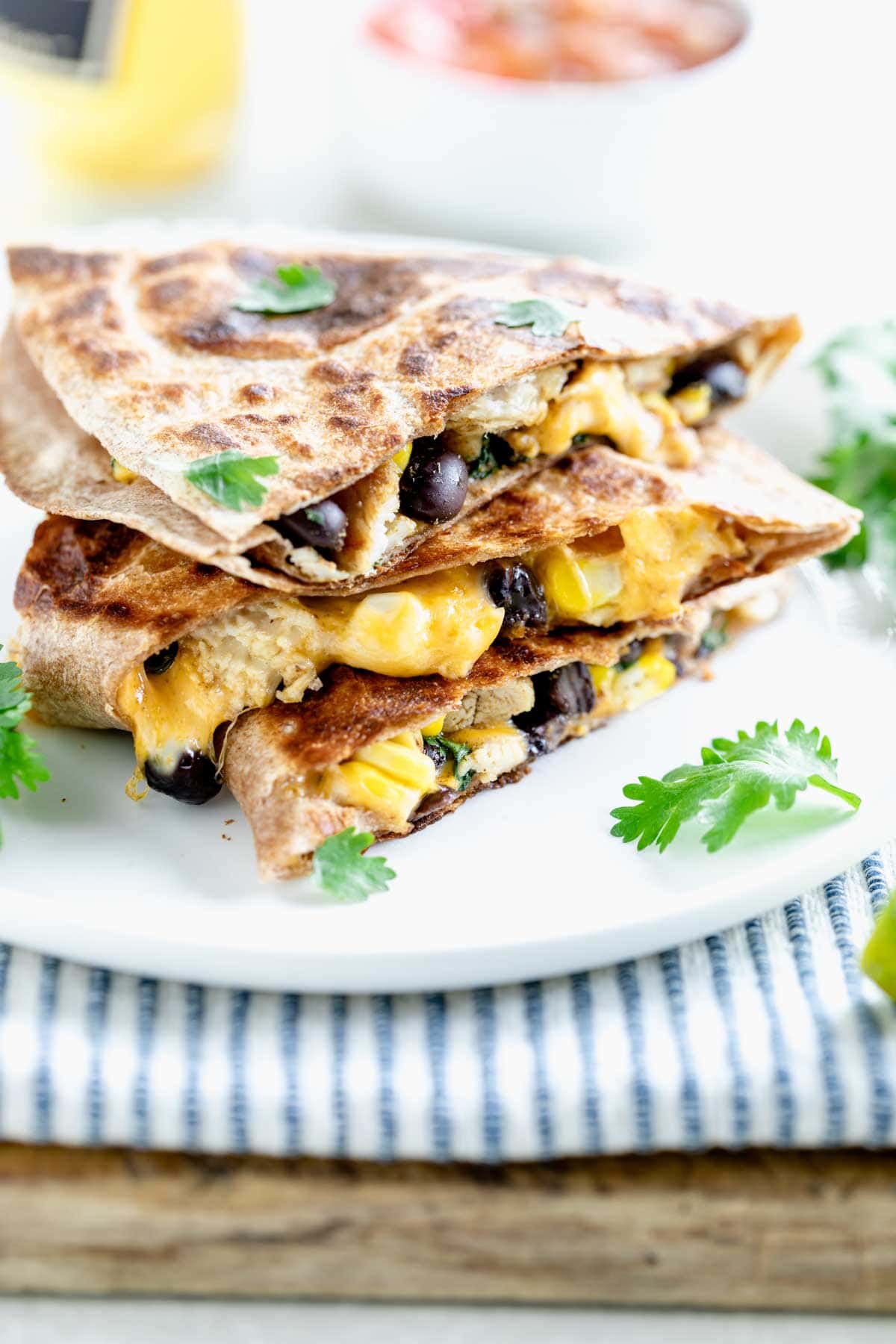 a stack of wedges of healthy chicken quesadillas with black beans and corn