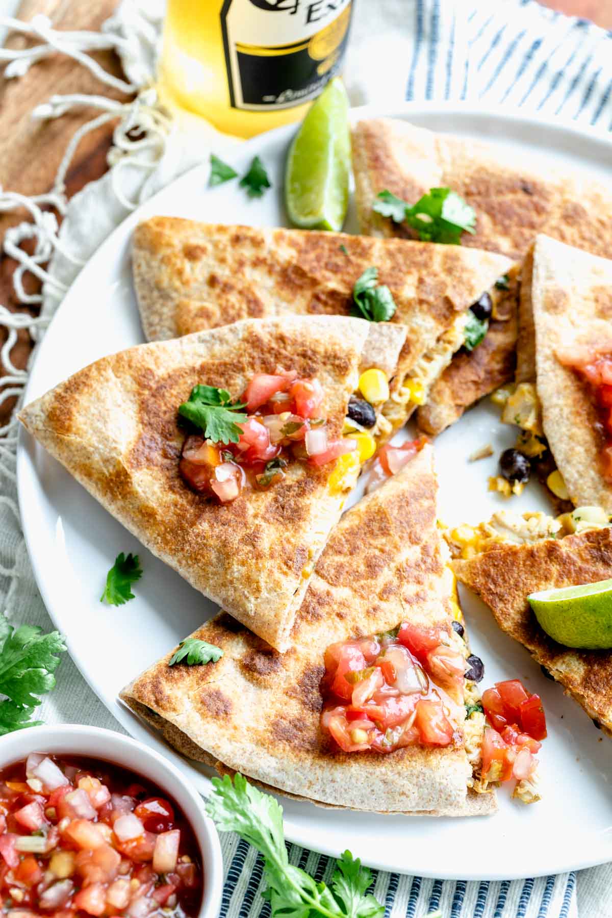 healthy chicken quesadillas cut into slices and topped with pico de gallo