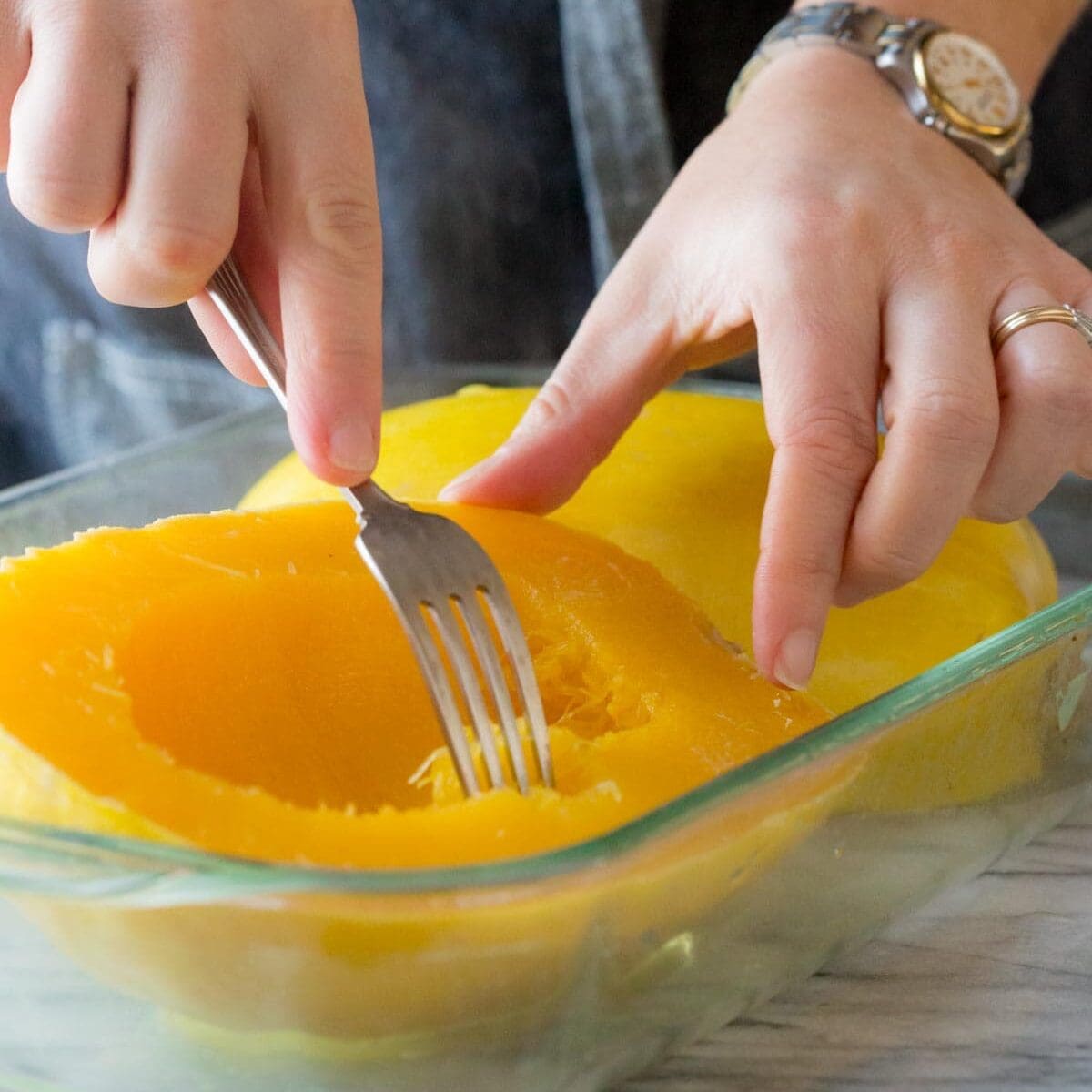 testing how tender the squash is with a fork