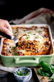 ground turkey lasagna slice on a spatula with the lasagna in the background
