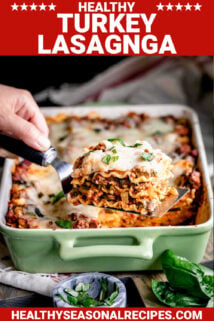 ground turkey lasagna slice on a spatula with the lasagna in the background