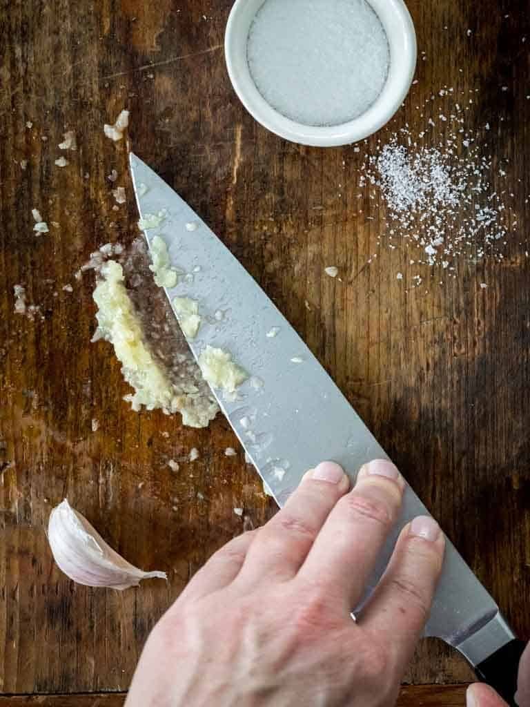 make a garlic paste with coarse salt