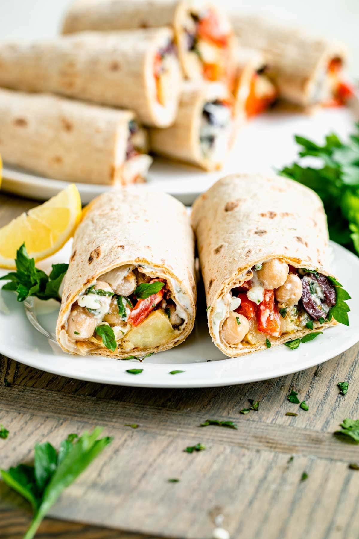 two roll-ups on a white plate with more in the background