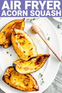 air fryer acorn squash on a plate beside a honey spoon