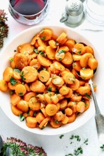 Carrots in a white bowl with a spoon