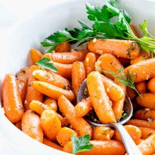 side view of the bowl of carrots with a spoonful resting on top