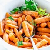 side view of the bowl of carrots with a spoonful resting on top