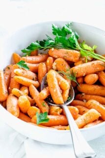 side view of the bowl of carrots with a spoonful resting on top