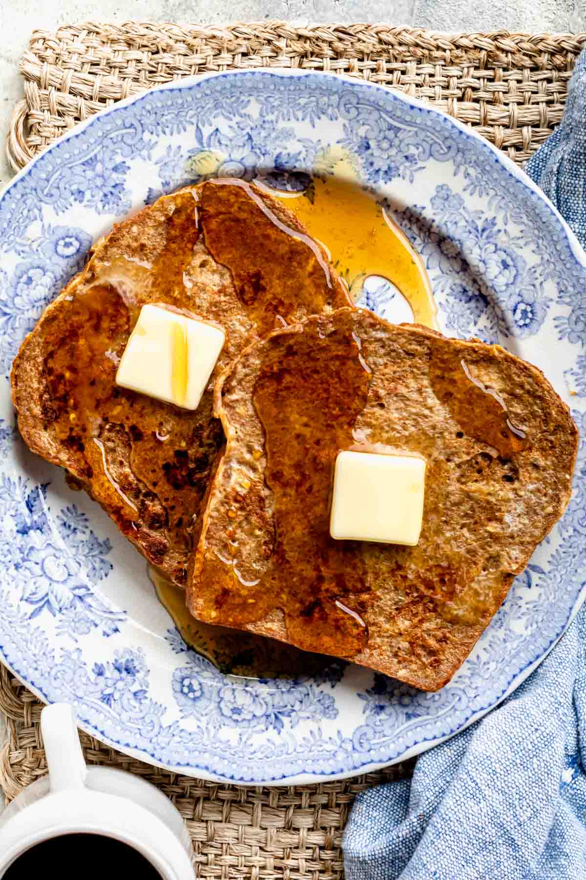 french toast with whole wheat bread topped with butter and drizzled with maple syrup