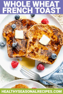 whole wheat french toast on a plate served with fruit and syrup