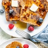 whole wheat french toast with fruit and maple syrup on plates