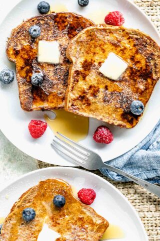 whole wheat french toast with fruit and maple syrup on plates