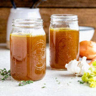 homemade vegetable stock cooled and stored in mason jars
