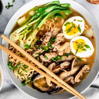 bok choy ramen noodle soup in a bowl with eggs and mushrooms