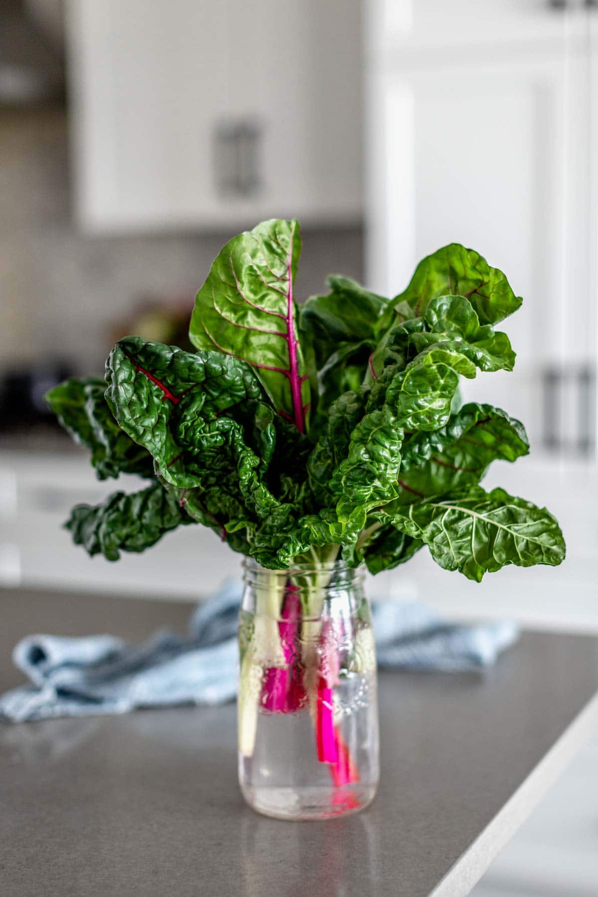 fresh swiss chard arranged in a jar