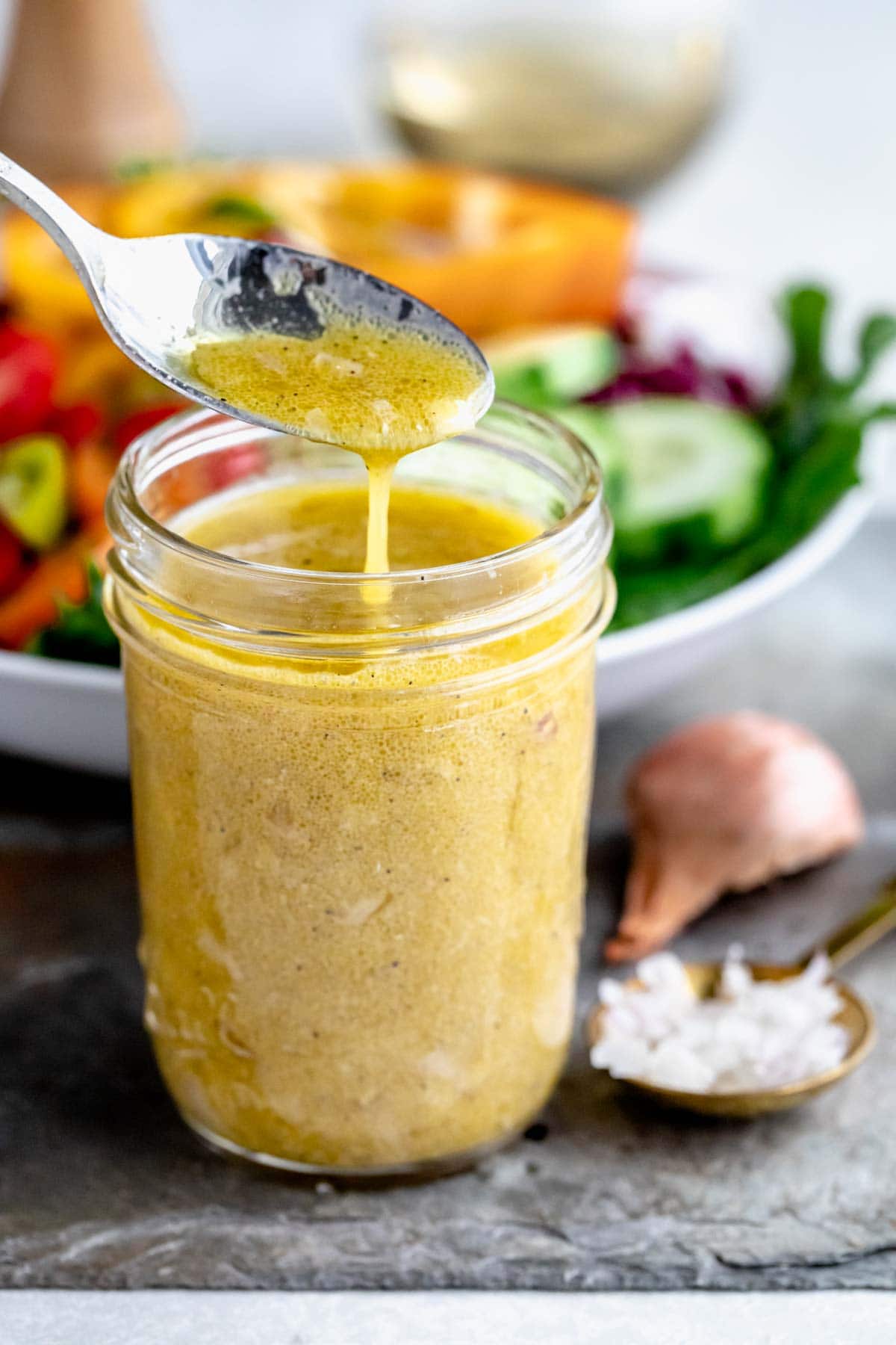 red wine vinegar in mason jar with salad behind