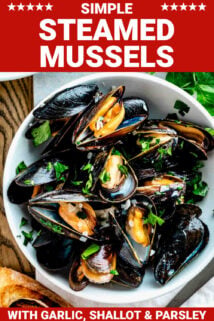 side angle of the mussels in a white bowl with grilled baguette