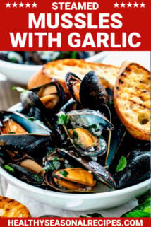 side angle of the mussels in a white bowl with grilled baguette