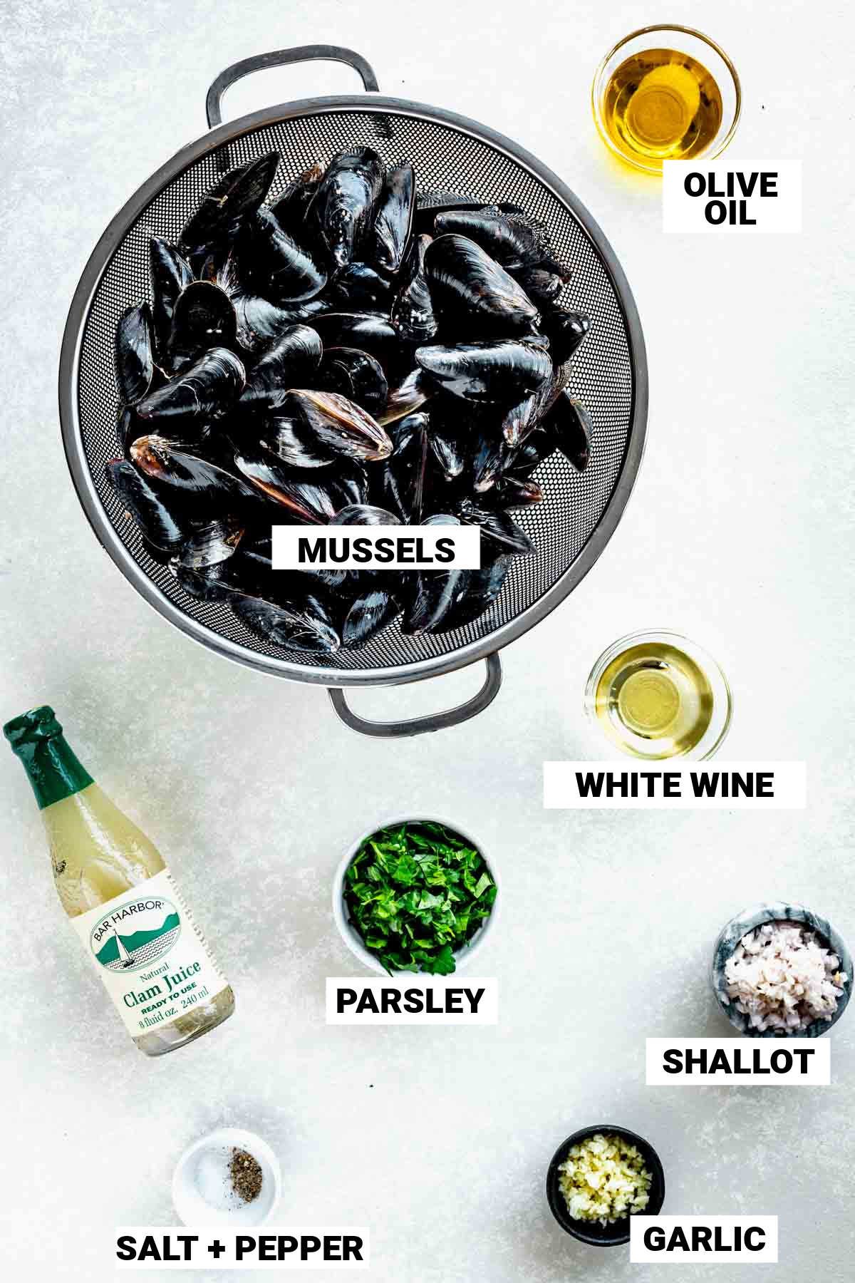 the mussels and other ingredients on a white table with text overlay