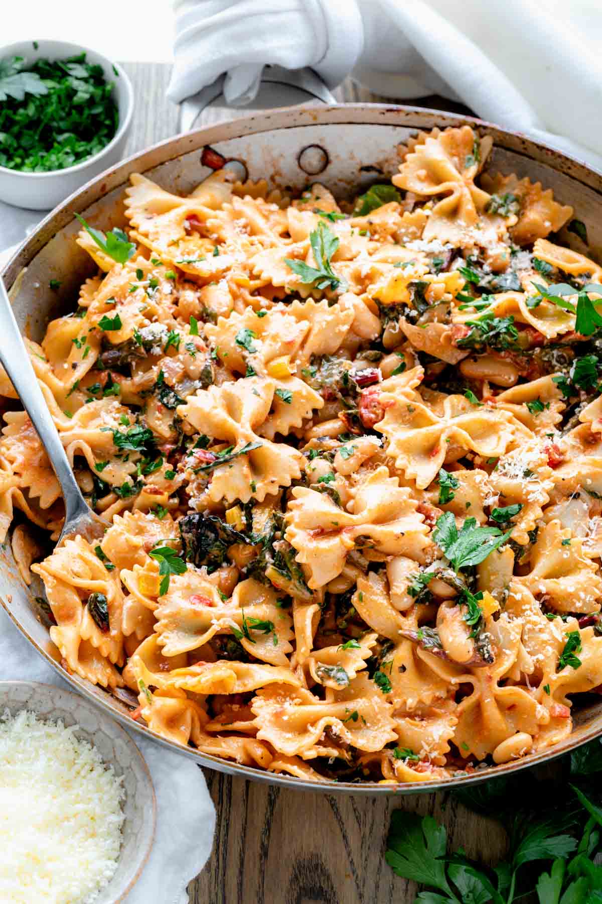 swish chard pasta in a bowl garnished with parsley and pecorino romano