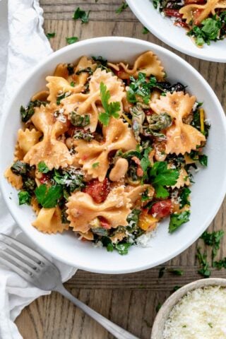 a serving of the swiss chard and farfalle pasta in a white bowl