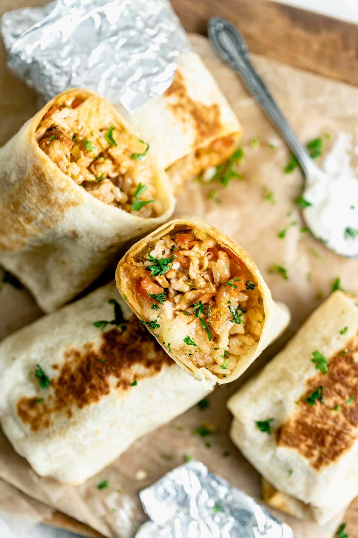 buffalo chicken burritos on cutting board