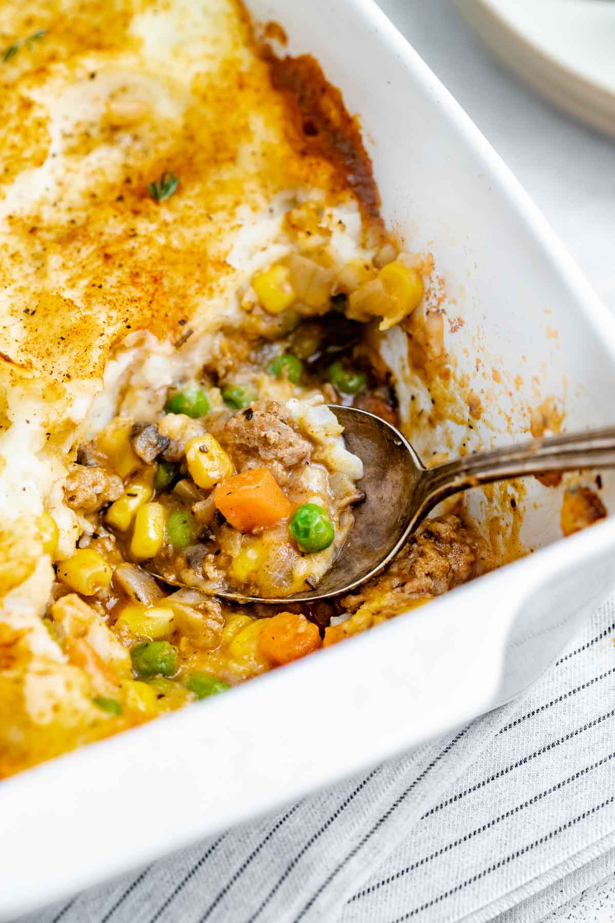 close up photo of a spoonful of shepherd's pie being scooped out by a spoon