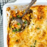 ground turkey shepherd's pie with a spoonful scooped out of the corner of the casserole dish with the spoon in the empty spot