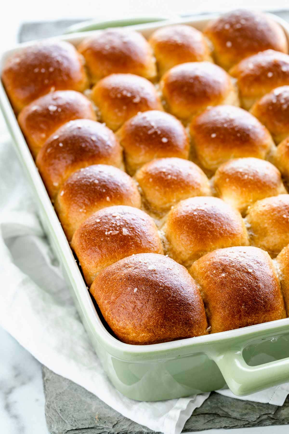 a pan full of whole wheat rolls browned and sprinkled with kosher salt