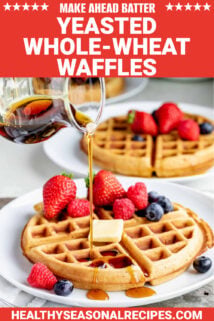 a waffle with fresh berries and text overlay that says "yeasted whole wheat waffles"