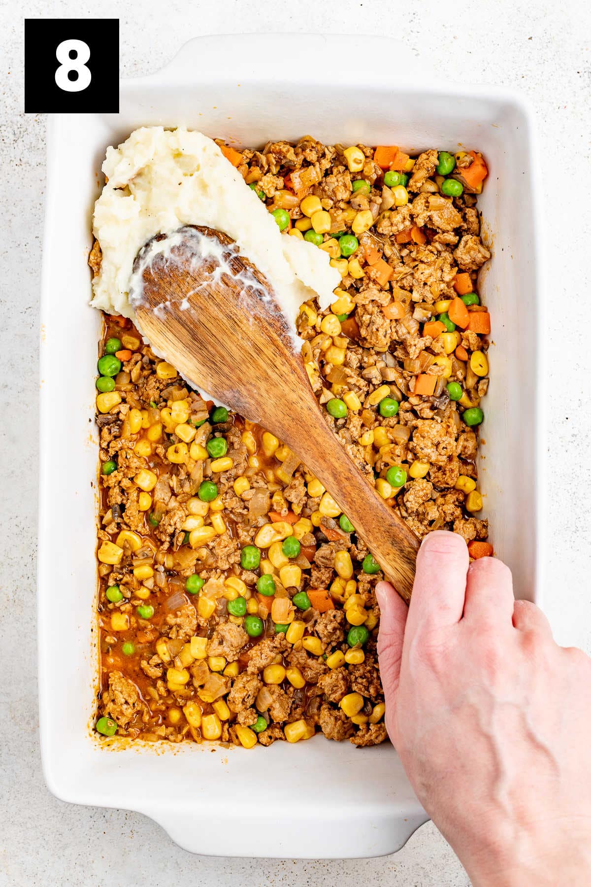 spread the mashed potatoes on top of the ground turkey and vegetable mxiture