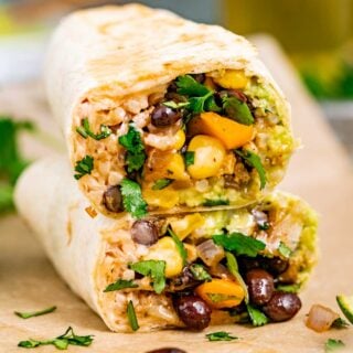 veggie burrito stuffed with brown rice, corn, and black beans cut in half and stacked on each other