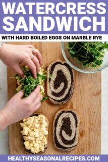 compiling a watercress sandwich with egg salad on rye bread