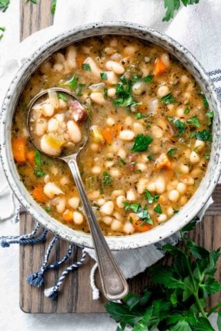 overhead shot of ham and white bean soup in bowl