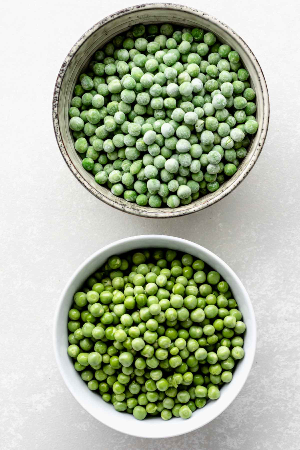 fresh and frozen peas side by side