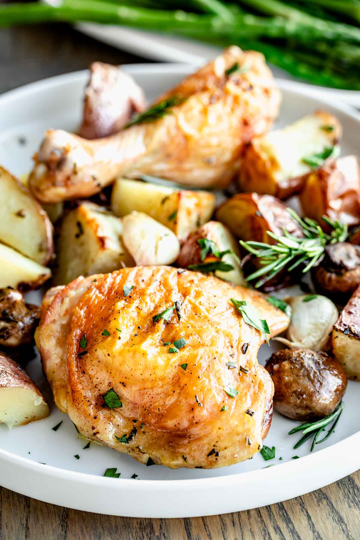 roasted chicken and potatoes on a circular white plate
