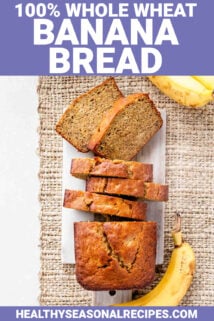 a loaf of whole wheat banana bread partially sliced into individual portions photographed from above
